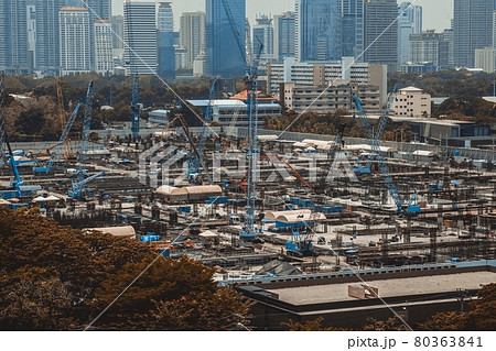Large construction site with heavy construction machinery in metropolis 80363841