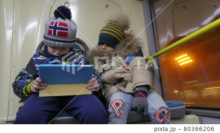 Timelapse of two boys with tablet computer in trolleybus Timelapse of two boys with tablet computer in trolleybus 80366206