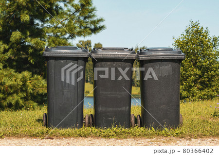 Three plastic waste bins in the city park Three plastic waste bins in the city park 80366402