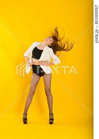 Full length studio portrait of beautiful woman in plaid jacket, white polka dot tights and boots Full length studio portrait of beautiful woman in plaid jacket, white polka dot tights and boots 80369097