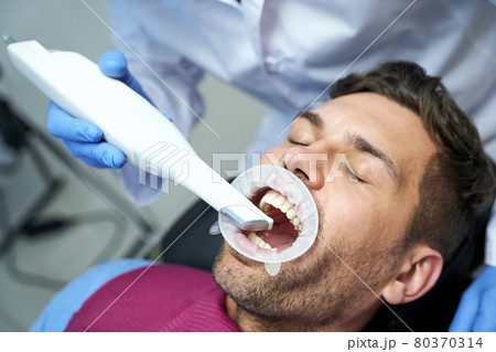 Cropped shot of dental procedure done to a male patient Cropped shot of dental procedure done to a male patient 80370314