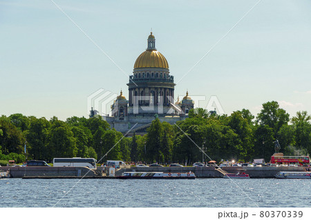 Isaac's Cathedral on Neva River shore and many tourists in buses and waterbuses 80370339