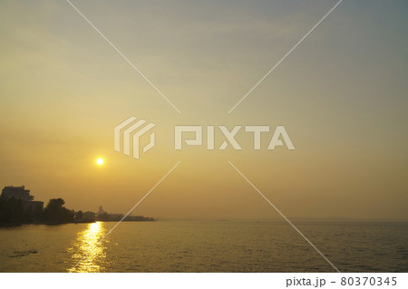 Smog from forest fires enveloped lake coast of city in summer day Smog from forest fires enveloped lake coast of city in summer day 80370345