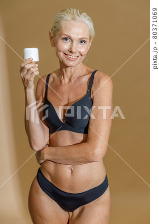 Studio Shot of Happy Mature Woman with Fit Body in Black Underwear Touching  Her Chin and Smiling Aside while Standing Stock Image - Image of face,  blonde: 219857989