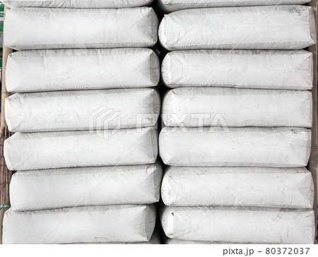 Pile of white plastic sacks in warehouse 80372037