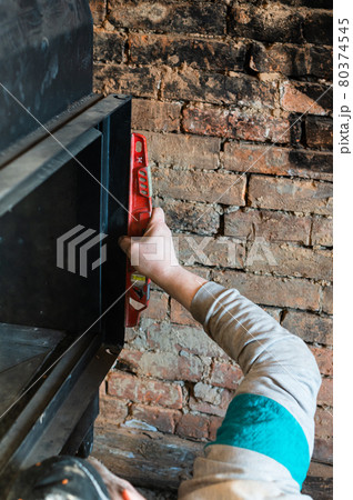 Installation of a large metal fireplace with a water circuit in the house, a profitable fireplace for heating. Installation of a large metal fireplace with a water circuit in the house, a profitable fireplace for heating. 80374545