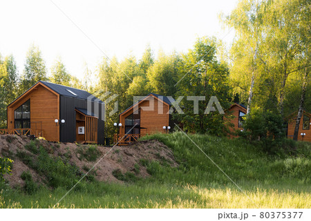 Barnhouse style houses. A street with cozy small houses. Modern construction 80375377