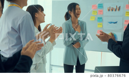 Businesswoman proficiently present work project receive celebrations from team 80376676