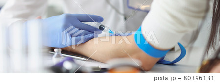Doctor gives an intravenous injection to patient in medical office 80396131
