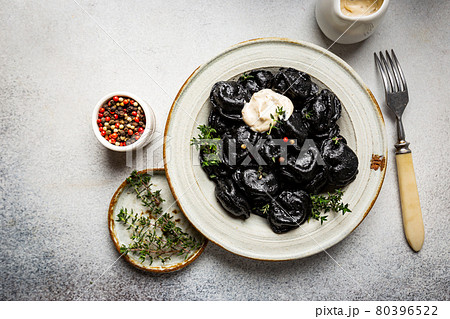 Plate of black dumplings Plate of black dumplings 80396522