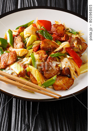 Twice cooked pork or double cooked pork is a Chinese dish include pork and stir-fried vegetables closeup in the plate. Vertical 80396805