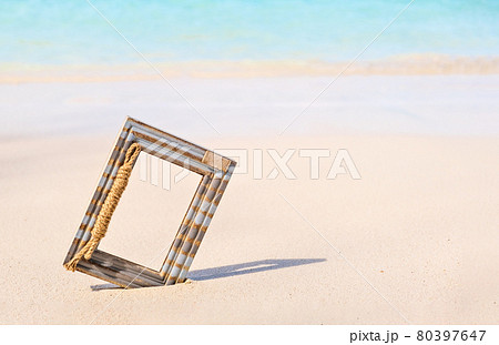 Wooden Photo frame on the tropical sea sand and the beach background with copy space 80397647