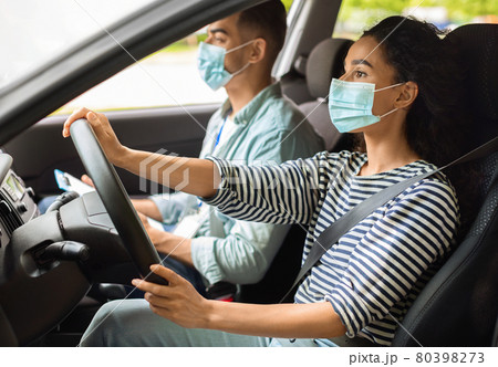 Brunette woman learning parking at driving school while pandemic Brunette woman learning parking at driving school while pandemic 80398273