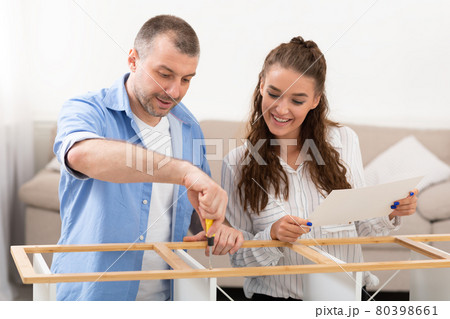 Happy Couple Installing Shelf Using Screwdriver Furnishing Home Happy Couple Installing Shelf Using Screwdriver Furnishing Home 80398661