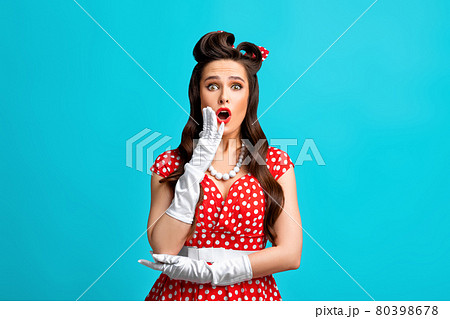 Emotional pinup woman in retro outfit over cannot believe amazing offer or sale, opening mouth in surprise Emotional pinup woman in retro outfit over cannot believe amazing offer or sale, opening mouth in surprise 80398678