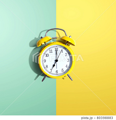 Yellow vintage alarm clock with shadow 80398883