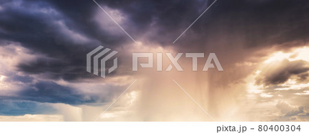 Heavy rainstorm in colorful stormy sky at evening 80400304