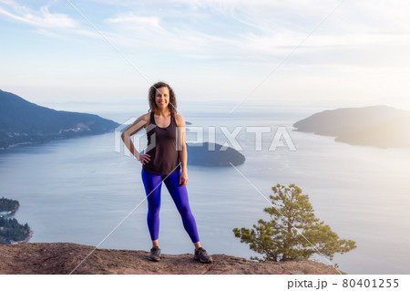 Adventurous Woman Hiking on top of Mountain Landscape 80401255