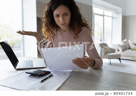 Confused Latin woman distressed with news in document Confused Latin woman distressed with news in document 80401734