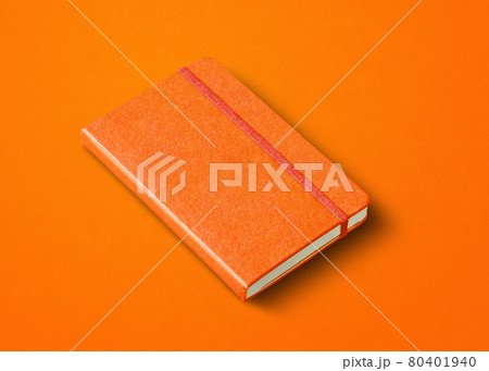 Orange closed notebook isolated on color background 80401940