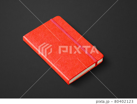 Red closed notebook isolated on black 80402123