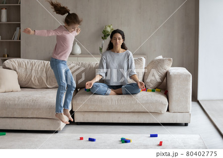 Calm mom mediate with small daughter play around 80402775
