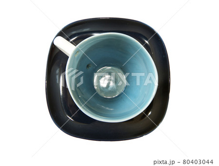 White tea cup with a spoon on the saucer, on a white background White tea cup with a spoon on the saucer, on a white background 80403044