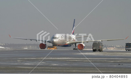 Tug towing ice covered aircraft of Aeroflot, Russia 80404893