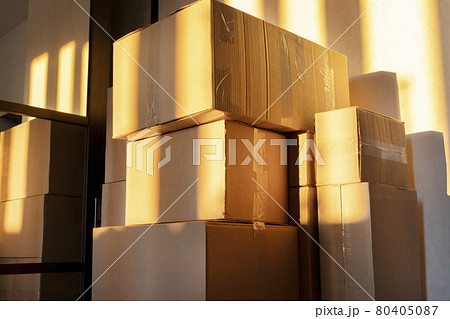 Cardboard boxes in the sun in a darkened room. Cardboard boxes in the sun in a darkened room. 80405087