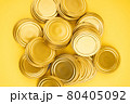 Lids for jars of gold color top view on a yellow background. 80405092