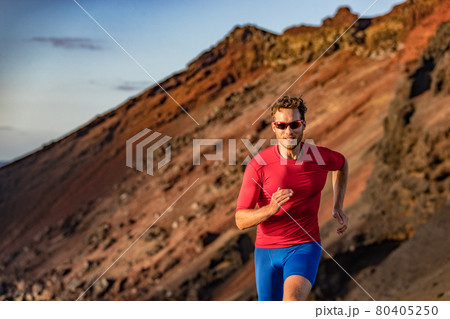 Trail runner on mountain run. Athlete man focused running training endurance. Fitness motivation. 80405250