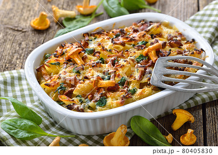 Chanterelle pasta casserole with spinach leaves and cheese served hot from the oven Chanterelle pasta casserole with spinach leaves and cheese served hot from the oven 80405830