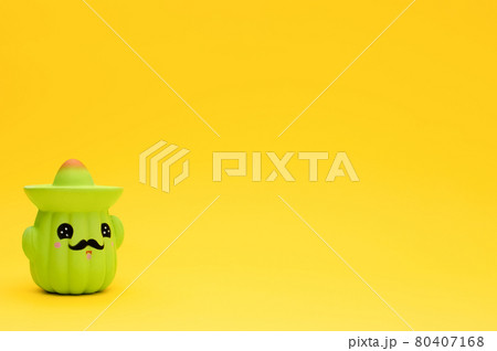 Toy cactus in sombrero on yellow background with copy space. 80407168