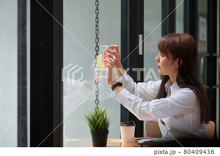 business woman post it notes idea discussing and planning in glass wall, Business financial concept. 80409436