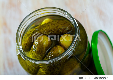 Glass bottle of marinated cucumbers Glass bottle of marinated cucumbers 80409971