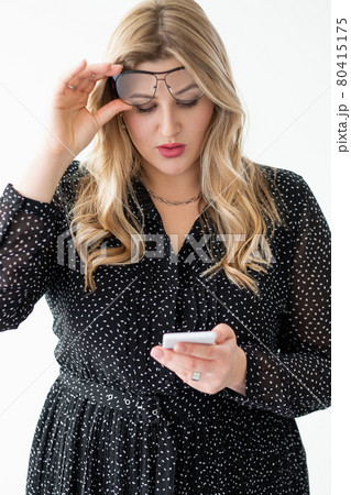 online offer surprised obese woman using phone 80415175