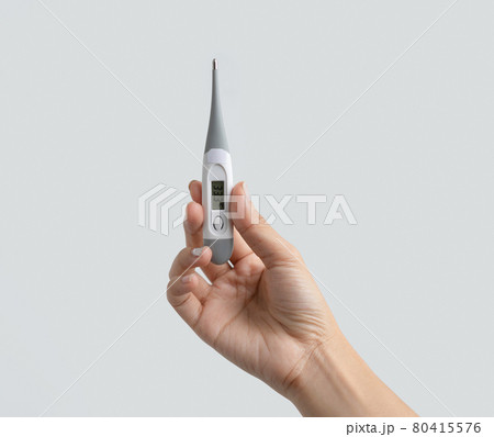 Hand hold an electronic medical thermometer isolated on white background. Fever or Diagnosis self check up. Medical and healthcare equipment. Coronavirus covid-19 outbreak. 80415576