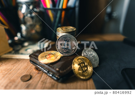 Bitcoin coins on a wooden desk 80416992