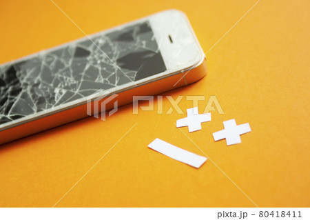Broken smartphone with cracked destroyed screen 80418411