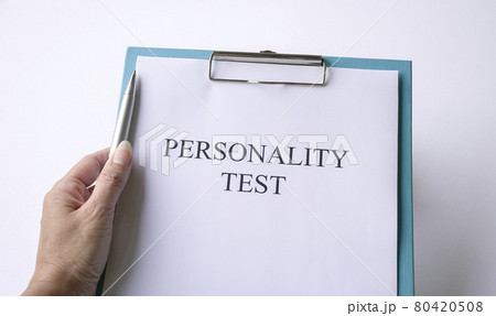Woman holding a pen with personality test. Woman holding a pen with personality test. 80420508