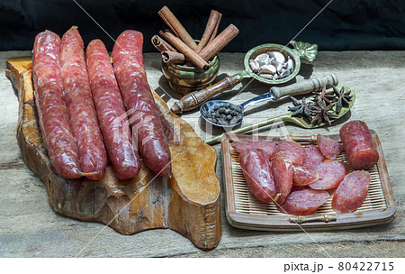 Dried Chinese sausage with herb on old wooden table. 80422715