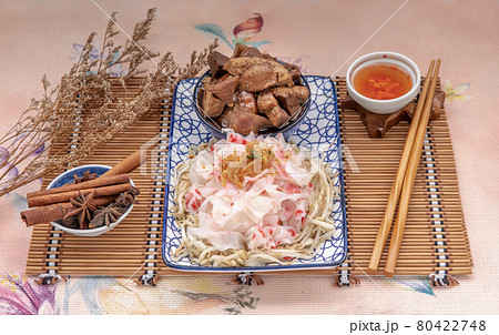 Chinese steamed rice noodles and bean sprout serve with Braised pork, Tofu, Crisp squid in sweet soy sauce in ceramic plate. Chinese steamed rice noodles and bean sprout serve with Braised pork, Tofu, Crisp squid in sweet soy sauce in ceramic plate. 80422748