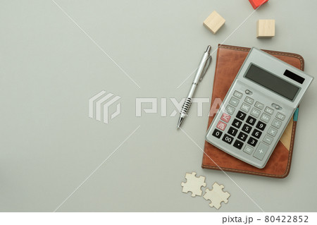 Table top view aerial image stationary business on office desk background concept. Flat lay objects calculator blank puzzle jigsaw pieces and wooden block on grey paper. solutions think or new idea, Table top view aerial image stationary business on office desk background concept. Flat lay objects calculator blank puzzle jigsaw pieces and wooden block on grey paper. solutions think or new idea, 80422852
