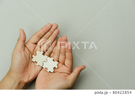 Top view of hand businessman holding blank puzzle jigsaw pieces. Teamwork success and strategy concept, cooperation business solutions think or new idea, Security help support management, copy space. Top view of hand businessman holding blank puzzle jigsaw pieces. Teamwork success and strategy concept, cooperation business solutions think or new idea, Security help support management, copy space. 80422854