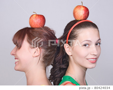 portrait of girl with apple on head portrait of girl with apple on head 80424034