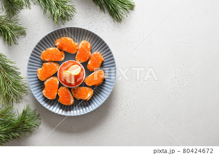 Russian appetizer canape with red caviar on white background for Christmas. Russian appetizer canape with red caviar on white background for Christmas. 80424672