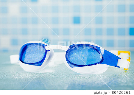 professional swimming glasses for training or competition, blue tile background 80426261