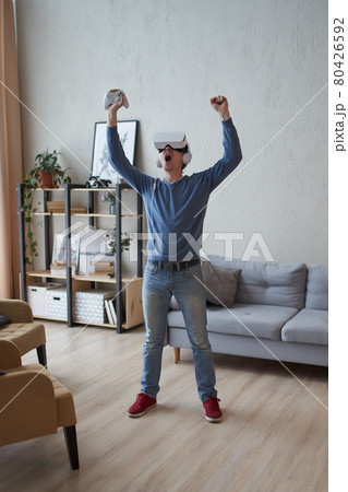 Man with virtual reality headset is playing game. Man with virtual reality headset is playing game. 80426592