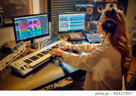 Female sound engineer at mixing consol Female sound engineer at mixing consol 80427907