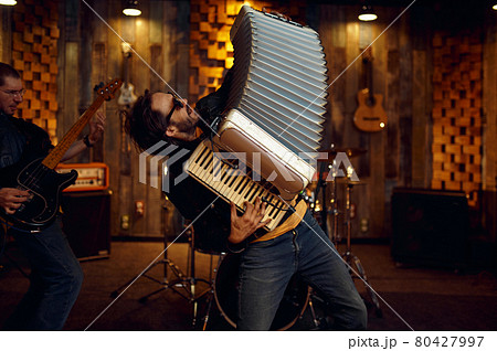 Two musicians with accordion and electric guitar Two musicians with accordion and electric guitar 80427997